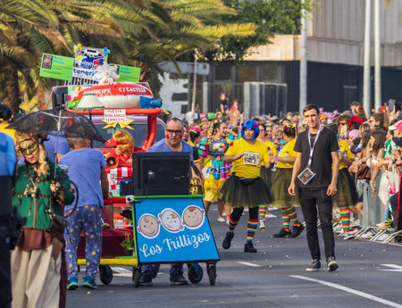 SANTA CRUZ DE TENERIFE, SPAIN - FEBRUARY 13, 2024: The Coso parade, Cavalcada - along the Avenida de Anaga, official end of Carnival. Amazing warm evening, joyful people in carnival costumes have fun.のeditorial素材
