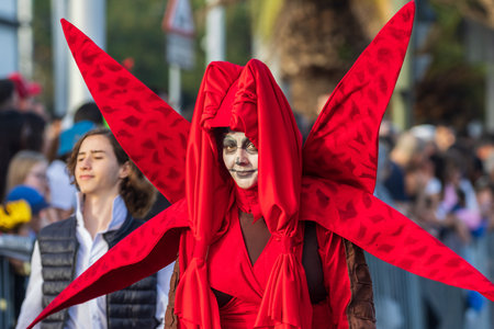 SANTA CRUZ DE TENERIFE, SPAIN - FEBRUARY 13, 2024: The Coso parade, Cavalcada - along the Avenida de Anaga, official end of Carnival. Amazing warm evening, joyful people in carnival costumes have fun.のeditorial素材