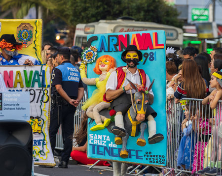 SANTA CRUZ DE TENERIFE, SPAIN - FEBRUARY 13, 2024: The Coso parade, Cavalcada - along the Avenida de Anaga, official end of Carnival. Amazing warm evening, joyful people in carnival costumes have fun.のeditorial素材
