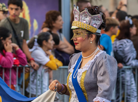 SANTA CRUZ DE TENERIFE, SPAIN - FEBRUARY 13, 2024: The Coso parade, Cavalcada - along the Avenida de Anaga, official end of Carnival. Amazing warm evening, joyful people in carnival costumes have fun.のeditorial素材
