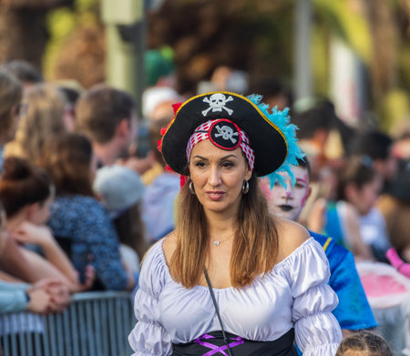 SANTA CRUZ DE TENERIFE, SPAIN - FEBRUARY 13, 2024: The Coso parade, Cavalcada - along the Avenida de Anaga, official end of Carnival. Amazing warm evening, joyful people in carnival costumes have fun.のeditorial素材