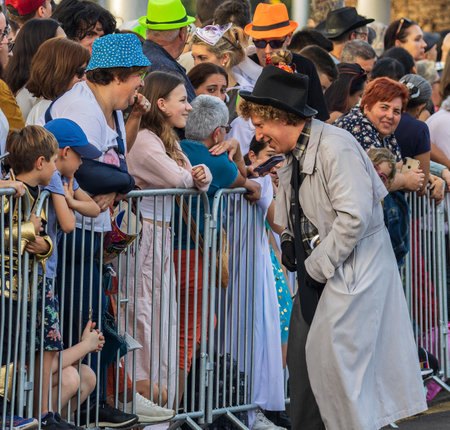 SANTA CRUZ DE TENERIFE, SPAIN - FEBRUARY 13, 2024: The Coso parade, Cavalcada - along the Avenida de Anaga, official end of Carnival. Amazing warm evening, joyful people in carnival costumes have fun.のeditorial素材