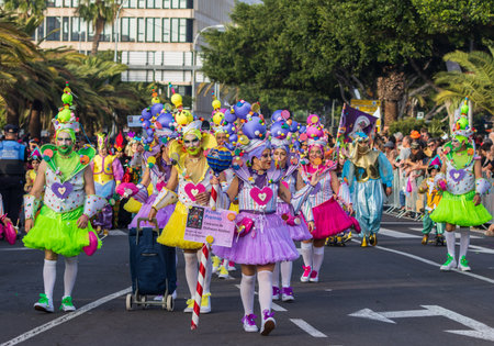 SANTA CRUZ DE TENERIFE, SPAIN - FEBRUARY 13, 2024: The Coso parade, Cavalcada - along the Avenida de Anaga, official end of Carnival. Amazing warm evening, joyful people in carnival costumes have fun.のeditorial素材