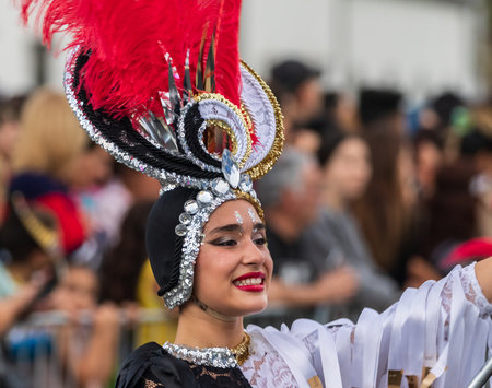 SANTA CRUZ DE TENERIFE, SPAIN - FEBRUARY 13, 2024: The Coso parade, Cavalcada - along the Avenida de Anaga, official end of Carnival. Amazing warm evening, joyful people in carnival costumes have fun.のeditorial素材