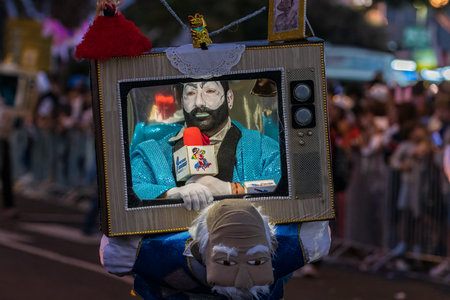 SANTA CRUZ DE TENERIFE, SPAIN - FEBRUARY 13, 2024: The Coso parade, Cavalcada - along the Avenida de Anaga, official end of Carnival. Amazing warm evening, joyful people in carnival costumes have fun.のeditorial素材