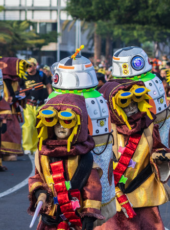 SANTA CRUZ DE TENERIFE, SPAIN - FEBRUARY 13, 2024: The Coso parade, Cavalcada - along the Avenida de Anaga, official end of Carnival. Amazing warm evening, joyful people in carnival costumes have fun.のeditorial素材