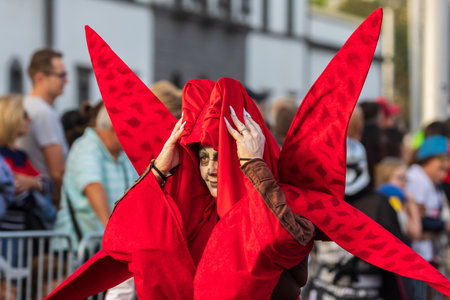 SANTA CRUZ DE TENERIFE, SPAIN - FEBRUARY 13, 2024: The Coso parade, Cavalcada - along the Avenida de Anaga, official end of Carnival. Amazing warm evening, joyful people in carnival costumes have fun.のeditorial素材