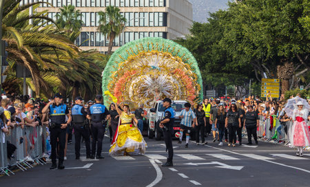 SANTA CRUZ DE TENERIFE, SPAIN - FEBRUARY 13, 2024: The Coso parade, Cavalcada - along the Avenida de Anaga, official end of Carnival. Amazing warm evening, joyful people in carnival costumes have fun.のeditorial素材