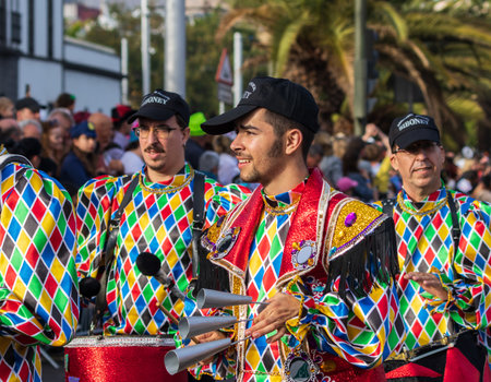 SANTA CRUZ DE TENERIFE, SPAIN - FEBRUARY 13, 2024: The Coso parade, Cavalcada - along the Avenida de Anaga, official end of Carnival. Amazing warm evening, joyful people in carnival costumes have fun.のeditorial素材