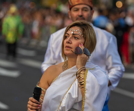 SANTA CRUZ DE TENERIFE, SPAIN - FEBRUARY 13, 2024: The Coso parade, Cavalcada - along the Avenida de Anaga, official end of Carnival. Amazing warm evening, joyful people in carnival costumes have fun.のeditorial素材