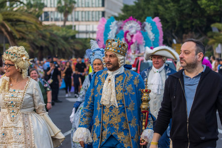SANTA CRUZ DE TENERIFE, SPAIN - FEBRUARY 13, 2024: The Coso parade, Cavalcada - along the Avenida de Anaga, official end of Carnival. Amazing warm evening, joyful people in carnival costumes have fun.のeditorial素材