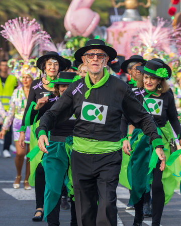 SANTA CRUZ DE TENERIFE, SPAIN - FEBRUARY 13, 2024: The Coso parade, Cavalcada - along the Avenida de Anaga, official end of Carnival. Amazing warm evening, joyful people in carnival costumes have fun.のeditorial素材