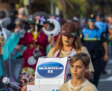 SANTA CRUZ DE TENERIFE, SPAIN - FEBRUARY 13, 2024: The Coso parade, Cavalcada - along the Avenida de Anaga, official end of Carnival. Amazing warm evening, joyful people in carnival costumes have fun.のeditorial素材