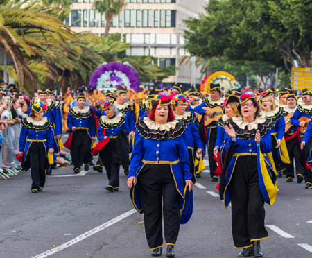 SANTA CRUZ DE TENERIFE, SPAIN - FEBRUARY 13, 2024: The Coso parade, Cavalcada - along the Avenida de Anaga, official end of Carnival. Amazing warm evening, joyful people in carnival costumes have fun.のeditorial素材