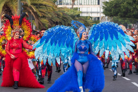 SANTA CRUZ DE TENERIFE, SPAIN - FEBRUARY 13, 2024: The Coso parade, Cavalcada - along the Avenida de Anaga, official end of Carnival. Amazing warm evening, joyful people in carnival costumes have fun.のeditorial素材