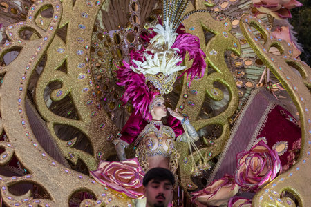 SANTA CRUZ DE TENERIFE, SPAIN - FEBRUARY 13, 2024: The Coso parade, Cavalcada - along the Avenida de Anaga, official end of Carnival. Amazing warm evening, joyful people in carnival costumes have fun.のeditorial素材