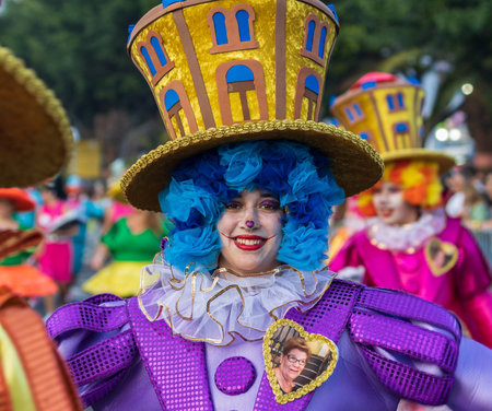 SANTA CRUZ DE TENERIFE, SPAIN - FEBRUARY 13, 2024: The Coso parade, Cavalcada - along the Avenida de Anaga, official end of Carnival. Amazing warm evening, joyful people in carnival costumes have fun.のeditorial素材