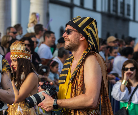 SANTA CRUZ DE TENERIFE, SPAIN - FEBRUARY 13, 2024: The Coso parade, Cavalcada - along the Avenida de Anaga, official end of Carnival. Amazing warm evening, joyful people in carnival costumes have fun.のeditorial素材