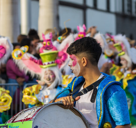 SANTA CRUZ DE TENERIFE, SPAIN - FEBRUARY 13, 2024: The Coso parade, Cavalcada - along the Avenida de Anaga, official end of Carnival. Amazing warm evening, joyful people in carnival costumes have fun.のeditorial素材