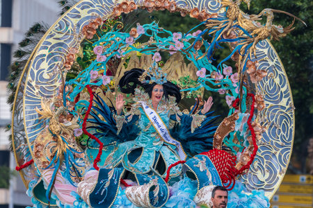 SANTA CRUZ DE TENERIFE, SPAIN - FEBRUARY 13, 2024: The Coso parade, Cavalcada - along the Avenida de Anaga, official end of Carnival. Amazing warm evening, joyful people in carnival costumes have fun.のeditorial素材