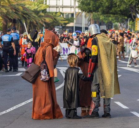 SANTA CRUZ DE TENERIFE, SPAIN - FEBRUARY 13, 2024: The Coso parade, Cavalcada - along the Avenida de Anaga, official end of Carnival. Amazing warm evening, joyful people in carnival costumes have fun.のeditorial素材