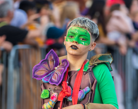 SANTA CRUZ DE TENERIFE, SPAIN - FEBRUARY 13, 2024: The Coso parade, Cavalcada - along the Avenida de Anaga, official end of Carnival. Amazing warm evening, joyful people in carnival costumes have fun.のeditorial素材