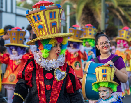 SANTA CRUZ DE TENERIFE, SPAIN - FEBRUARY 13, 2024: The Coso parade, Cavalcada - along the Avenida de Anaga, official end of Carnival. Amazing warm evening, joyful people in carnival costumes have fun.のeditorial素材