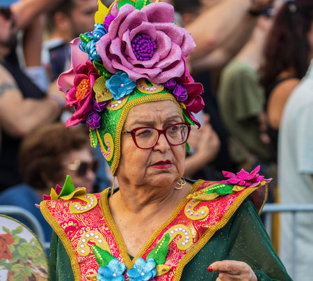 SANTA CRUZ DE TENERIFE, SPAIN - FEBRUARY 13, 2024: The Coso parade, Cavalcada - along the Avenida de Anaga, official end of Carnival. Amazing warm evening, joyful people in carnival costumes have fun.のeditorial素材