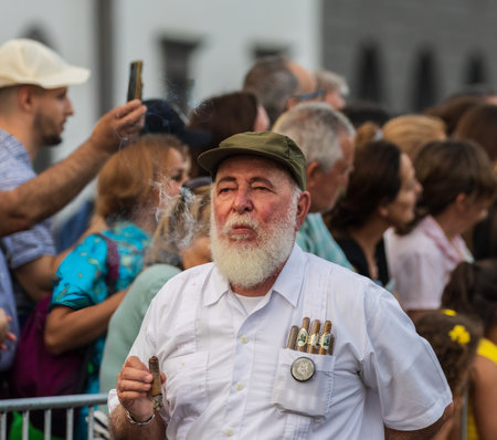 SANTA CRUZ DE TENERIFE, SPAIN - FEBRUARY 13, 2024: The Coso parade, Cavalcada - along the Avenida de Anaga, official end of Carnival. Amazing warm evening, joyful people in carnival costumes have fun.のeditorial素材