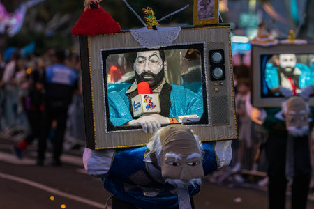 SANTA CRUZ DE TENERIFE, SPAIN - FEBRUARY 13, 2024: The Coso parade, Cavalcada - along the Avenida de Anaga, official end of Carnival. Amazing warm evening, joyful people in carnival costumes have fun.のeditorial素材