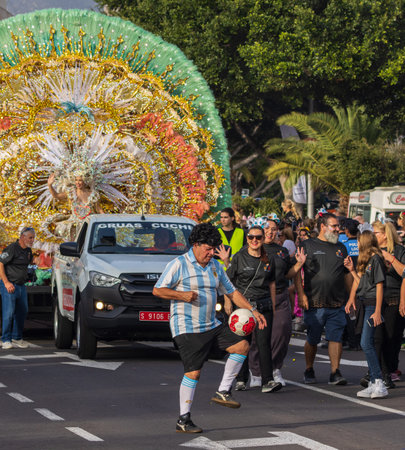 SANTA CRUZ DE TENERIFE, SPAIN - FEBRUARY 13, 2024: The Coso parade, Cavalcada - along the Avenida de Anaga, official end of Carnival. Amazing warm evening, joyful people in carnival costumes have fun.のeditorial素材