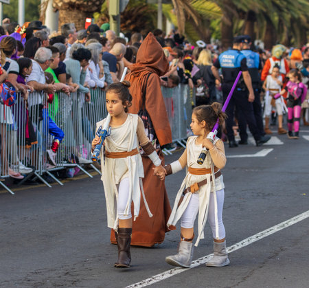 SANTA CRUZ DE TENERIFE, SPAIN - FEBRUARY 13, 2024: The Coso parade, Cavalcada - along the Avenida de Anaga, official end of Carnival. Amazing warm evening, joyful people in carnival costumes have fun.のeditorial素材