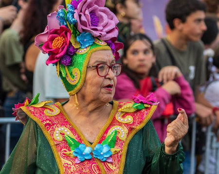 SANTA CRUZ DE TENERIFE, SPAIN - FEBRUARY 13, 2024: The Coso parade, Cavalcada - along the Avenida de Anaga, official end of Carnival. Amazing warm evening, joyful people in carnival costumes have fun.のeditorial素材