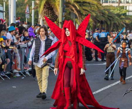 SANTA CRUZ DE TENERIFE, SPAIN - FEBRUARY 13, 2024: The Coso parade, Cavalcada - along the Avenida de Anaga, official end of Carnival. Amazing warm evening, joyful people in carnival costumes have fun.のeditorial素材