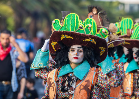 SANTA CRUZ DE TENERIFE, SPAIN - FEBRUARY 13, 2024: The Coso parade, Cavalcada - along the Avenida de Anaga, official end of Carnival. Amazing warm evening, joyful people in carnival costumes have fun.のeditorial素材