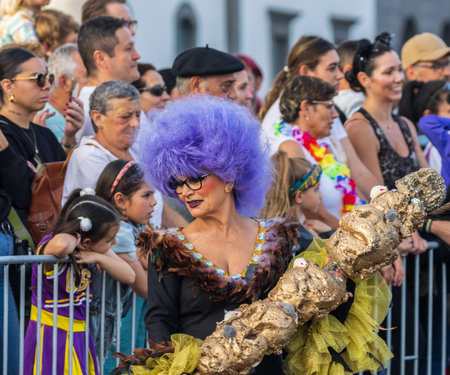 SANTA CRUZ DE TENERIFE, SPAIN - FEBRUARY 13, 2024: The Coso parade, Cavalcada - along the Avenida de Anaga, official end of Carnival. Amazing warm evening, joyful people in carnival costumes have fun.のeditorial素材