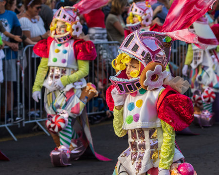 SANTA CRUZ DE TENERIFE, SPAIN - FEBRUARY 13, 2024: The Coso parade, Cavalcada - along the Avenida de Anaga, official end of Carnival. Amazing warm evening, joyful people in carnival costumes have fun.のeditorial素材