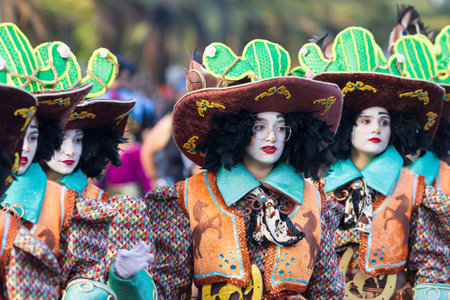 SANTA CRUZ DE TENERIFE, SPAIN - FEBRUARY 13, 2024: The Coso parade, Cavalcada - along the Avenida de Anaga, official end of Carnival. Amazing warm evening, joyful people in carnival costumes have fun.のeditorial素材