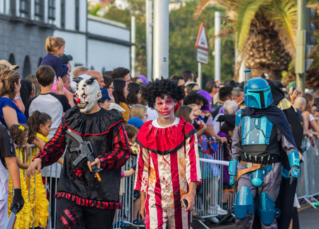 SANTA CRUZ DE TENERIFE, SPAIN - FEBRUARY 13, 2024: The Coso parade, Cavalcada - along the Avenida de Anaga, official end of Carnival. Amazing warm evening, joyful people in carnival costumes have fun.のeditorial素材