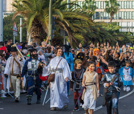 SANTA CRUZ DE TENERIFE, SPAIN - FEBRUARY 13, 2024: The Coso parade, Cavalcada - along the Avenida de Anaga, official end of Carnival. Amazing warm evening, joyful people in carnival costumes have fun.のeditorial素材