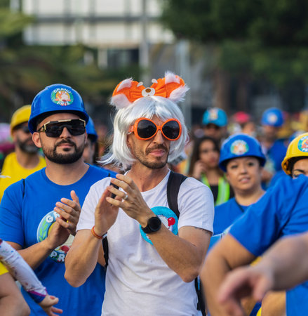 SANTA CRUZ DE TENERIFE, SPAIN - FEBRUARY 13, 2024: The Coso parade, Cavalcada - along the Avenida de Anaga, official end of Carnival. Amazing warm evening, joyful people in carnival costumes have fun.のeditorial素材