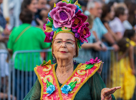 SANTA CRUZ DE TENERIFE, SPAIN - FEBRUARY 13, 2024: The Coso parade, Cavalcada - along the Avenida de Anaga, official end of Carnival. Amazing warm evening, joyful people in carnival costumes have fun.のeditorial素材