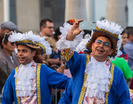 SANTA CRUZ DE TENERIFE, SPAIN - FEBRUARY 13, 2024: The Coso parade, Cavalcada - along the Avenida de Anaga, official end of Carnival. Amazing warm evening, joyful people in carnival costumes have fun.のeditorial素材