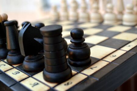 Wooden chess pieces on a chess Boardの写真素材
