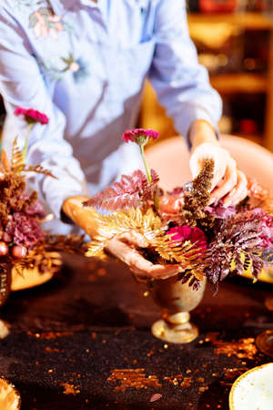 Table setting. Hands lay the napkin on the plate. Selected focus and blurred background.の写真素材