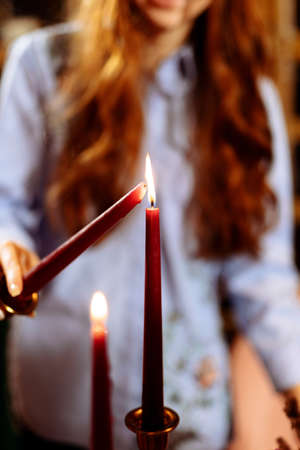 A woman lights candles at Wedding. Blurred background and selectedの写真素材