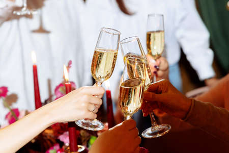 A girl lights a red candle at a party. Selected focus and blurred backgroundの写真素材