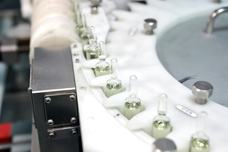 Sterile bottles and ampoules on the dispensing line. Sealed ampoules with medicine.の写真素材