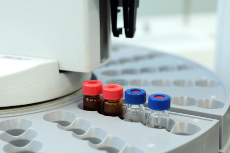 Quality Control Laboratory medicine. Chromatograph operation. Bottles check on the quality of the suspension. Vials on autosampler of gas chromatography-mass spectrophotometer. Ampoules are chemical control suspension in the gas chromatograph. Gas chromatの写真素材