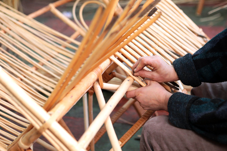 Production of furniture from the vine. Factory of creation of natural furniture. Manual production of furniture from wood. Wicker chair.の写真素材